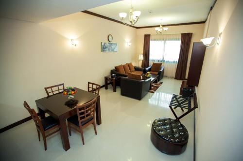 an overhead view of a living room with a table and chairs at Xclusive Maples Hotel Apartment in Dubai