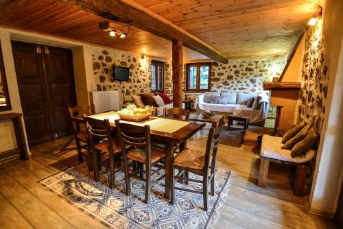 a living room with a wooden table and chairs at Εν Αρχή - En Arhi in Ano Trikala