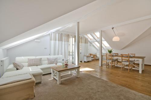 a living room with a white couch and a table at Imperial Apartments - Nautica in Sopot