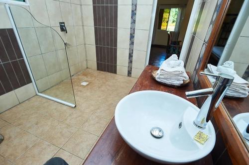 a bathroom with a sink and a shower at Riviera Garden in Antananarivo