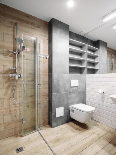 a bathroom with a shower and a toilet in it at OW Posejdon Dźwirzyno in Dźwirzyno