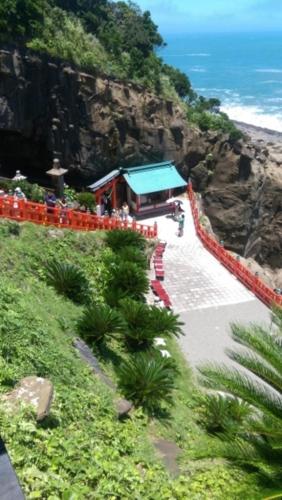 a train station on a cliff next to the ocean at Dormy Inn Miyazaki Natural Hot Spring in Miyazaki