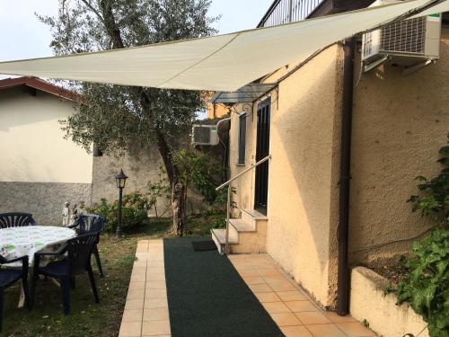 awning over a patio with a table and chairs at Hotel Vela Azzurra in Malcesine