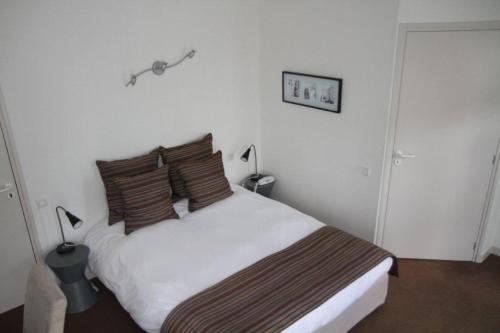 Postel nebo postele na pokoji v ubytování Hotel Le Suroit