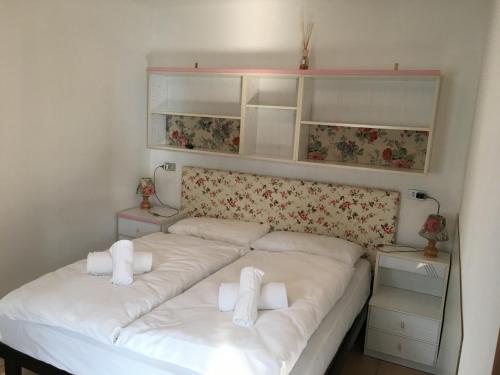 a bedroom with a bed with two white pillows at Hotel Vela Azzurra in Malcesine