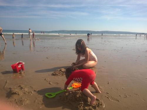 two children playing in the sand on the beach at Turlin Valley in Poole