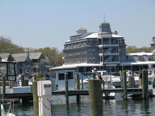 a large building sitting next to a marina with boats at Summercamp in Oak Bluffs