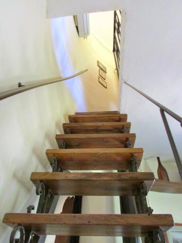 a staircase with wooden steps in a building at Agriturismo "Borgo Madonna degli Angeli" - charming cottages in the gardens ! in Tocco da Casauria