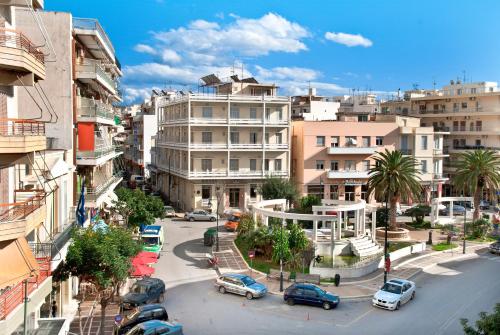 a city with cars parked on a street with buildings at Vassilikon Hotel in Loutraki