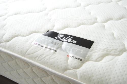 a mattress with a label on top of it at remm Hibiya in Tokyo
