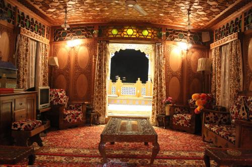 a living room with a table and a window at House Boat New Lucifer in Srinagar