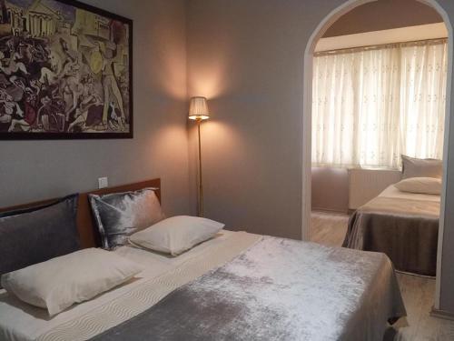 a bedroom with two beds and a large window at Masal Otel in Kocaeli