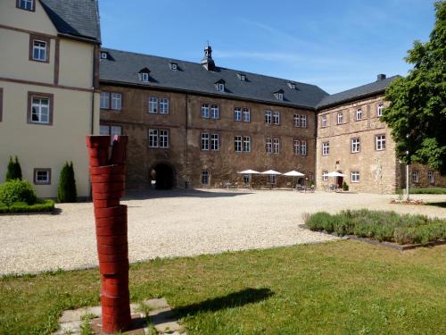 a brick pole in front of a large building at Schloss Hotel Wallhausen in Wallhausen