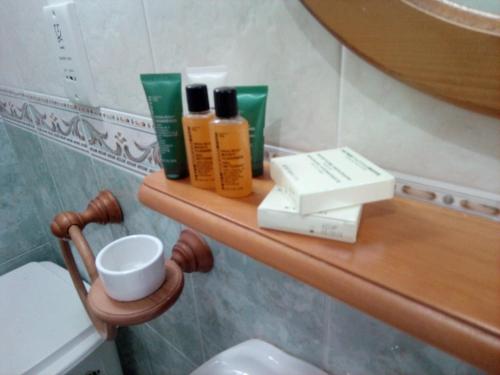 a bathroom with a shelf with toiletries on it at Coral Reef Flat 7 in Marsalforn