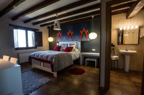 a bedroom with a bed and a desk and a sink at Casa Rural Andutza in Ea