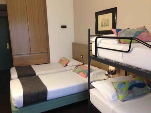 two bunk beds in a room with a door at Hotel Forum in SantʼIlario dʼEnza