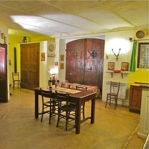 a room with a table and chairs in a room at Agriturismo "Borgo Madonna degli Angeli" - charming cottages in the gardens ! in Tocco da Casauria