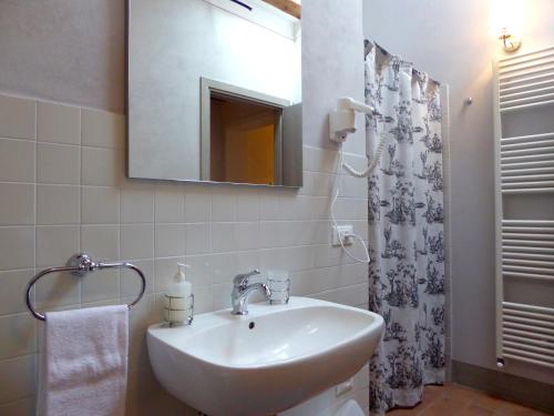 a bathroom with a sink and a mirror and a shower at Casa Vacanze Villa Cerine in Altopascio