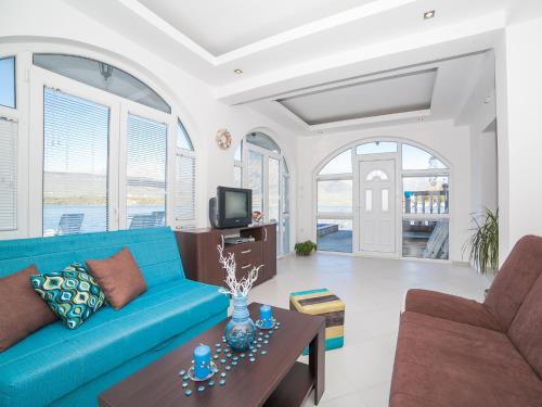 a living room with a blue couch and a table at Apartments Elena in Tivat