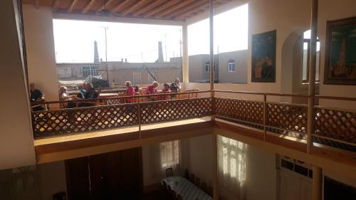 a group of people standing on a balcony of a building at Islambek Hotel & Travel in Khiva