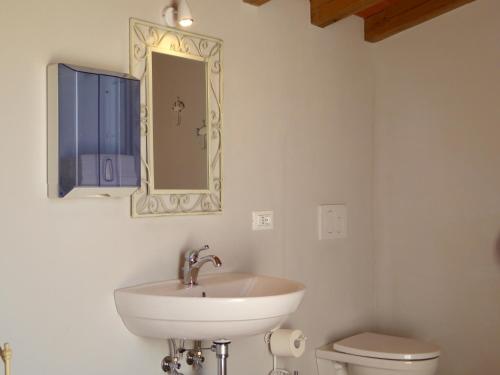 a bathroom with a sink and a toilet at Casa Vacanze Villa Cerine in Altopascio