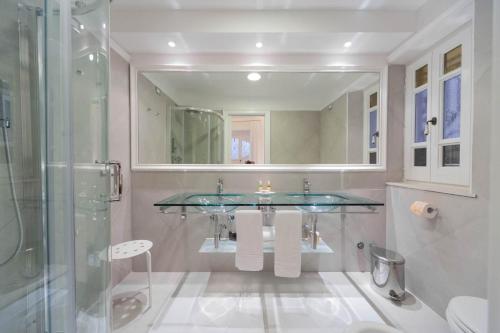 a bathroom with a glass sink and a shower at La Settima Luna Hotel in Canneto