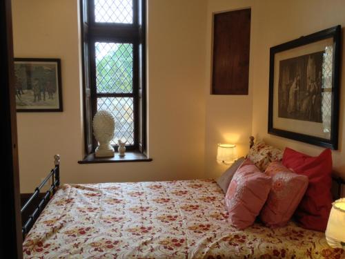 a bedroom with a bed and a window at Château de la Grange Fort in Issoire