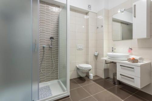 a bathroom with a shower and a toilet and a sink at Apartments Biserka in Bol