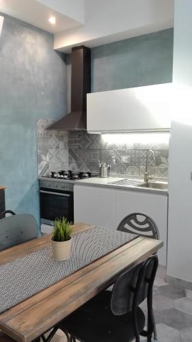 a kitchen with a table and a sink and a stove at Veracini apartment in Florence