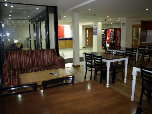 a restaurant with a table and chairs and a dining room at 247Hotel in Oldham