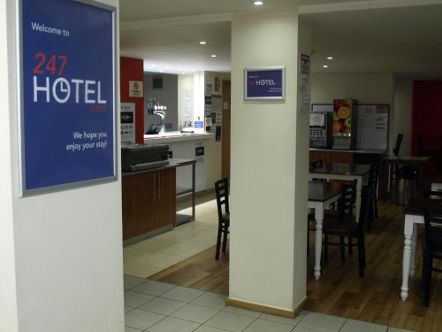 a hotel room with a sign on a wall at 247Hotel in Oldham