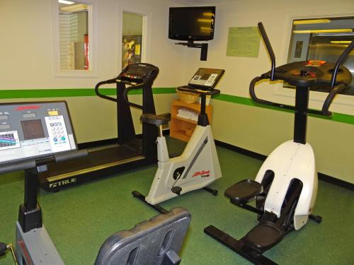 a gym with two exercise bikes and a treadmill at Extended Stay America Select Suites - Raleigh - Cary - Regency Parkway South in Cary