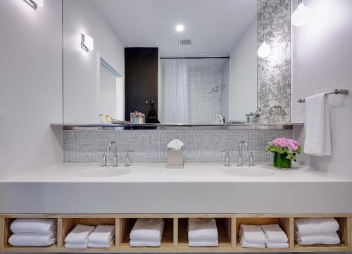 a bathroom with two sinks and a large mirror at NU Hotel in Brooklyn