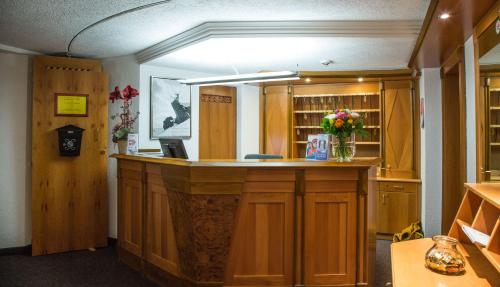 a large kitchen with a counter with flowers on it at Hotel Kristall in Sankt Anton am Arlberg