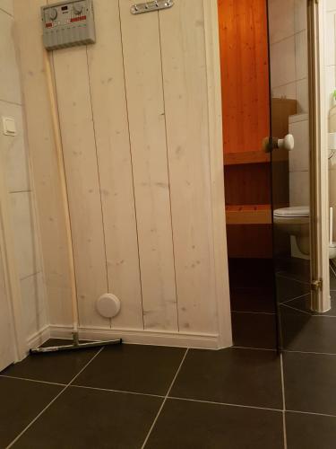 a bathroom with white cabinets and a toilet at Glafsfjordens Accommodatie in Arvika