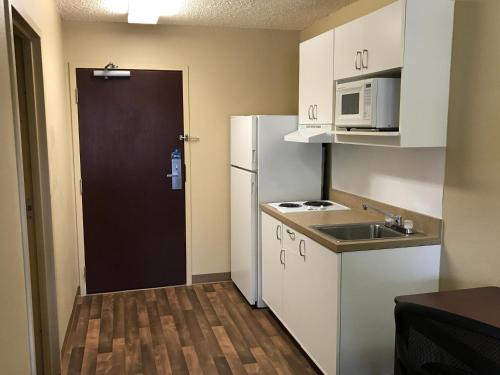 a small kitchen with a white refrigerator and a sink at Extended Stay America Suites - Boise - Airport in Boise