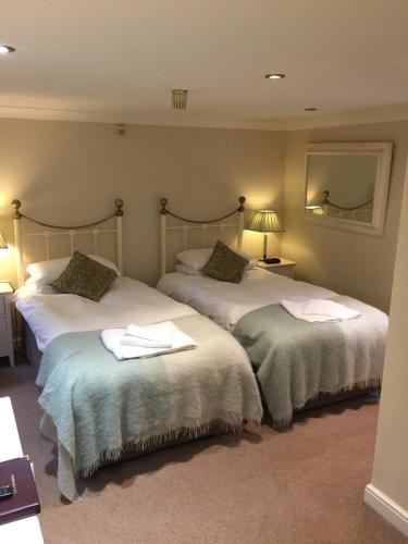 a hotel room with two beds with towels on them at The Old Rectory in King's Lynn