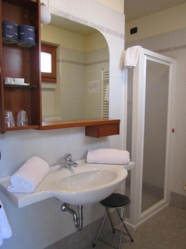 a bathroom with a sink and a mirror at Hotel Villa Isabella in Brenzone sul Garda