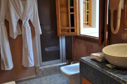 a bathroom with a sink and a toilet at Riad Andalib in Fès