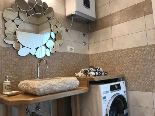 a bathroom with a washing machine and a mirror at Luxury Apartment Valentina in Split