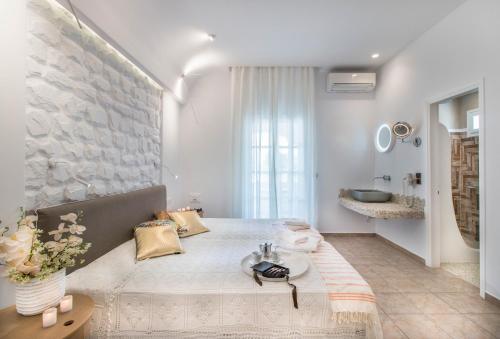 a bedroom with a bed and a stone wall at Spiros in Naxos Chora