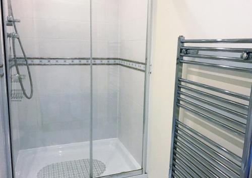 a shower with a glass door in a bathroom at Hartford Court in Bournemouth