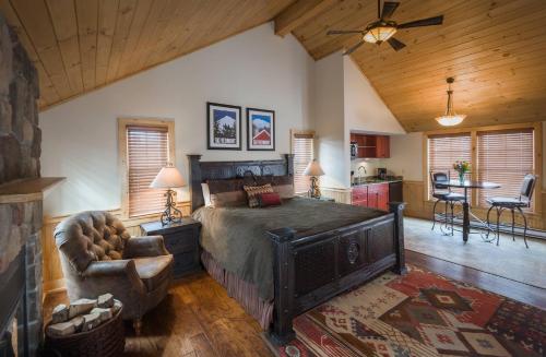 a bedroom with a large bed and a kitchen at The Mountain Top Inn & Resort in Chittenden