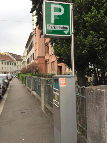a parking meter on the side of a street at Apartment Una - Self check in in Graz