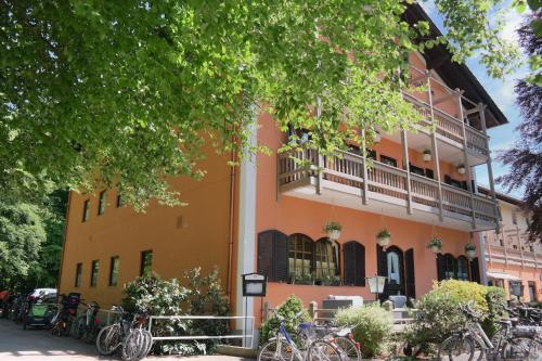 a building with bikes parked in front of it at Hotel Waldgasthof Buchenhain in Baierbrunn