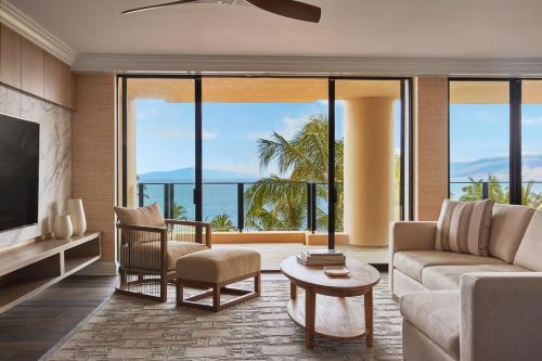 a living room with a couch and a tv at Four Seasons Resort Maui at Wailea in Wailea