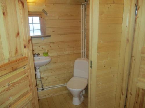a bathroom with a toilet and a sink at Smyrill Cottages in Þórshöfn