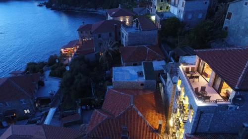 an aerial view of a town by the water at night at Apartments Timoni in Ulcinj