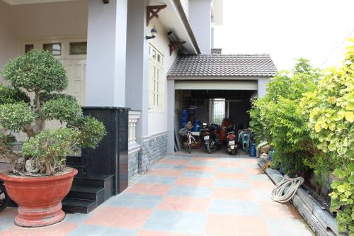 a house with a garage with a motorcycle parked in it at Hoang Gia Doc Let in Doc Let