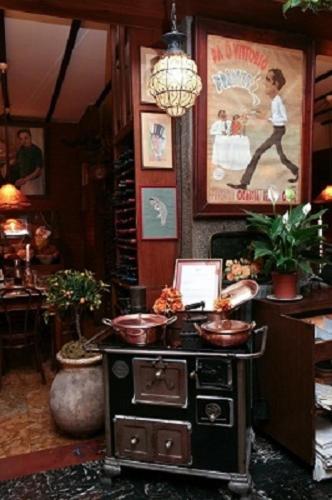 a room with a stove and a painting on the wall at Da ö Vittorio SRL in Recco